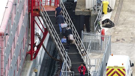 UK government rejects claims it was slow to evacuate asylum seekers after bacteria detected on barge